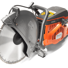 Husqvarna K 970 6.5 HP gas-powered circular saw cutting concrete or stone with blade attachment.