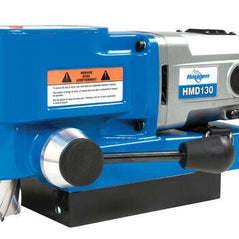 Hougen HMD130 magnetic drill with ultra low profile design, 115V, 1-3/8 inch capacity, shown in close-up on a metal surface.